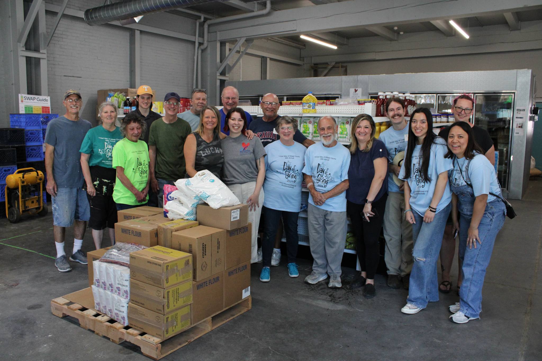 Volunteers posing together in warehouse